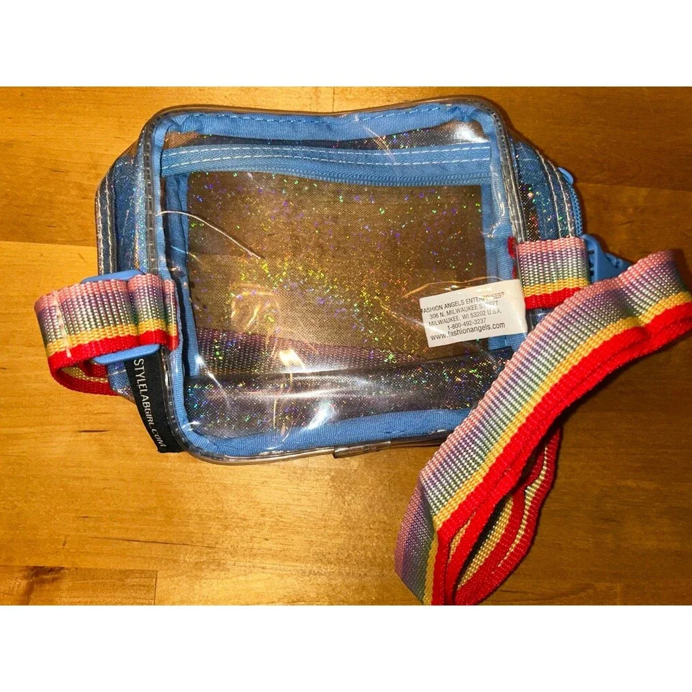 Girls Clear crossbody purse with blue trim and adjustable rainbow strap
